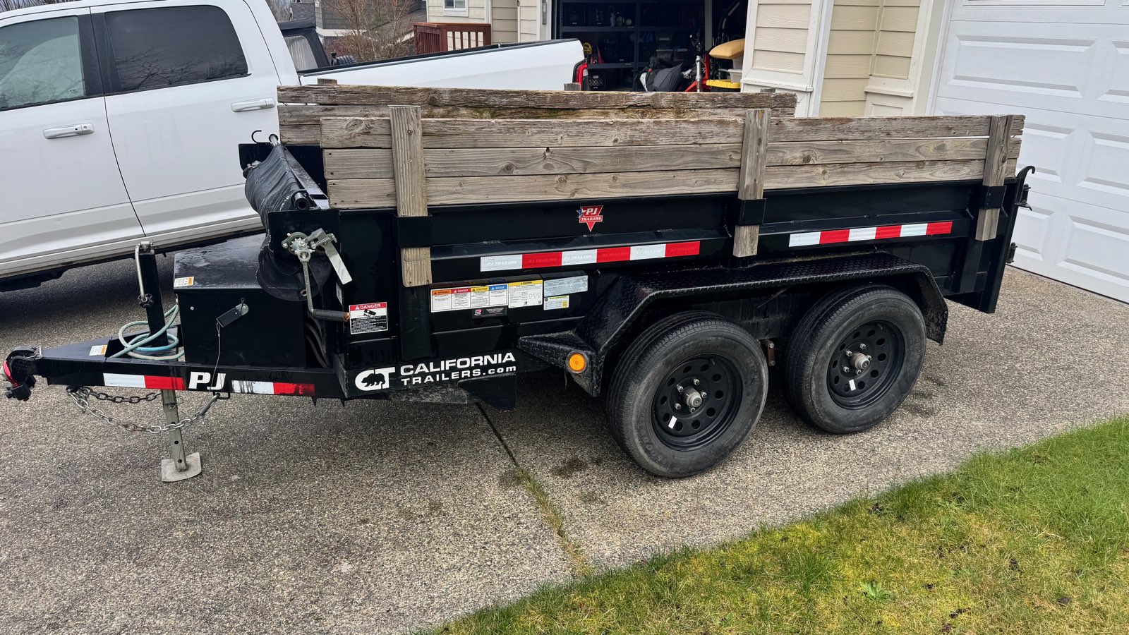 2022 PJ 5x10 hydraulic dump trailer parked on a driveway